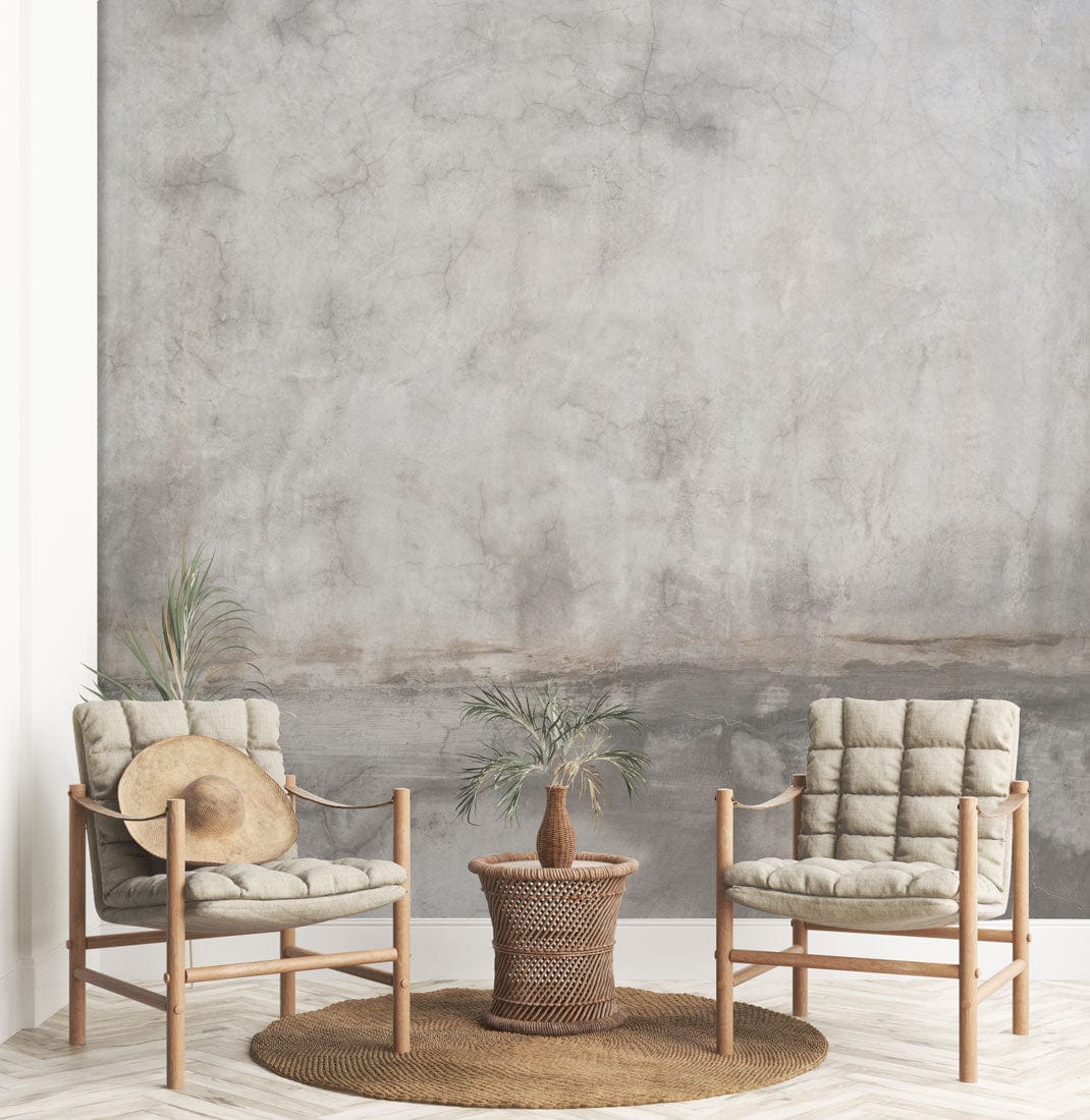 Subtle Vintage Concrete Texture Wallpaper, muted grey tones, wooden chairs, woven rug, minimalist decor.