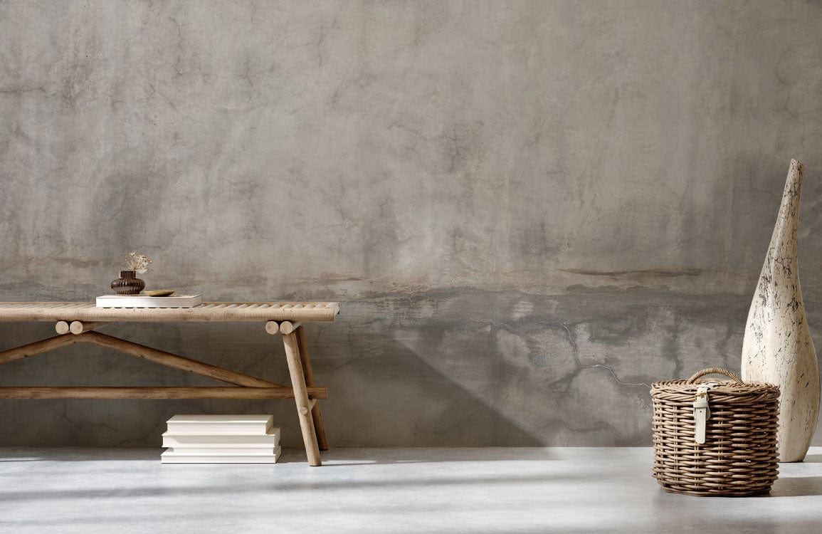 Subtle vintage concrete wallpaper in muted grey, rustic bench, wicker basket, minimalist interior design.