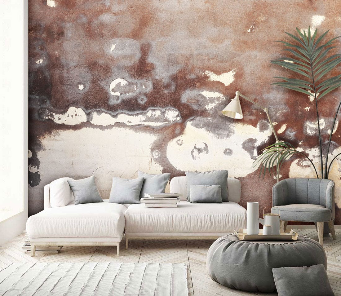Alt text: Vintage aged mural wallpaper, earthy tones, cream sofa, grey armchair, wooden flooring, modern living room.