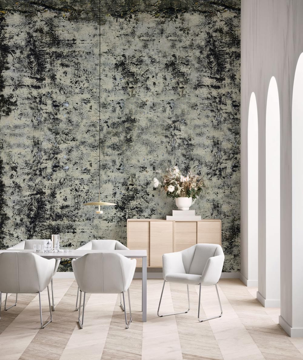 Industrial grey distressed wallpaper with white chairs, light wood sideboard, and modern dining area flooring.
