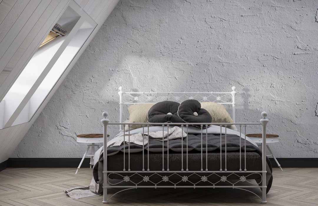 Alt text: Bedroom with Elegant Textured Grey Plaster Effect Wallpaper, metal bed, wooden flooring, attic window.