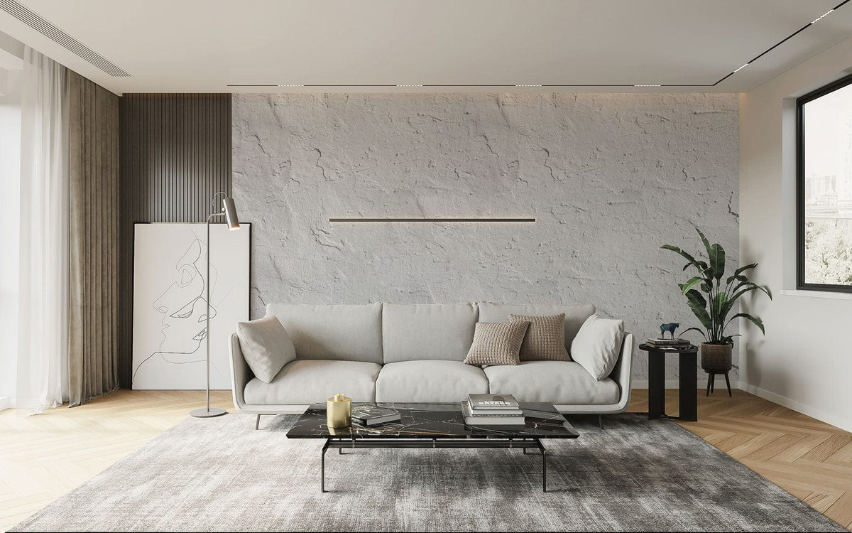 Elegant textured grey plaster wallpaper in modern living room, with beige sofa, glass table, light wood flooring.