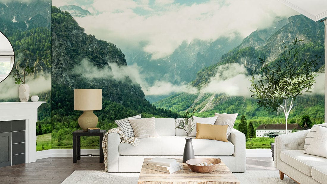 Tranquil Mountain Lake Mural Wallpaper in living room with beige sofas, white fireplace, wooden flooring.