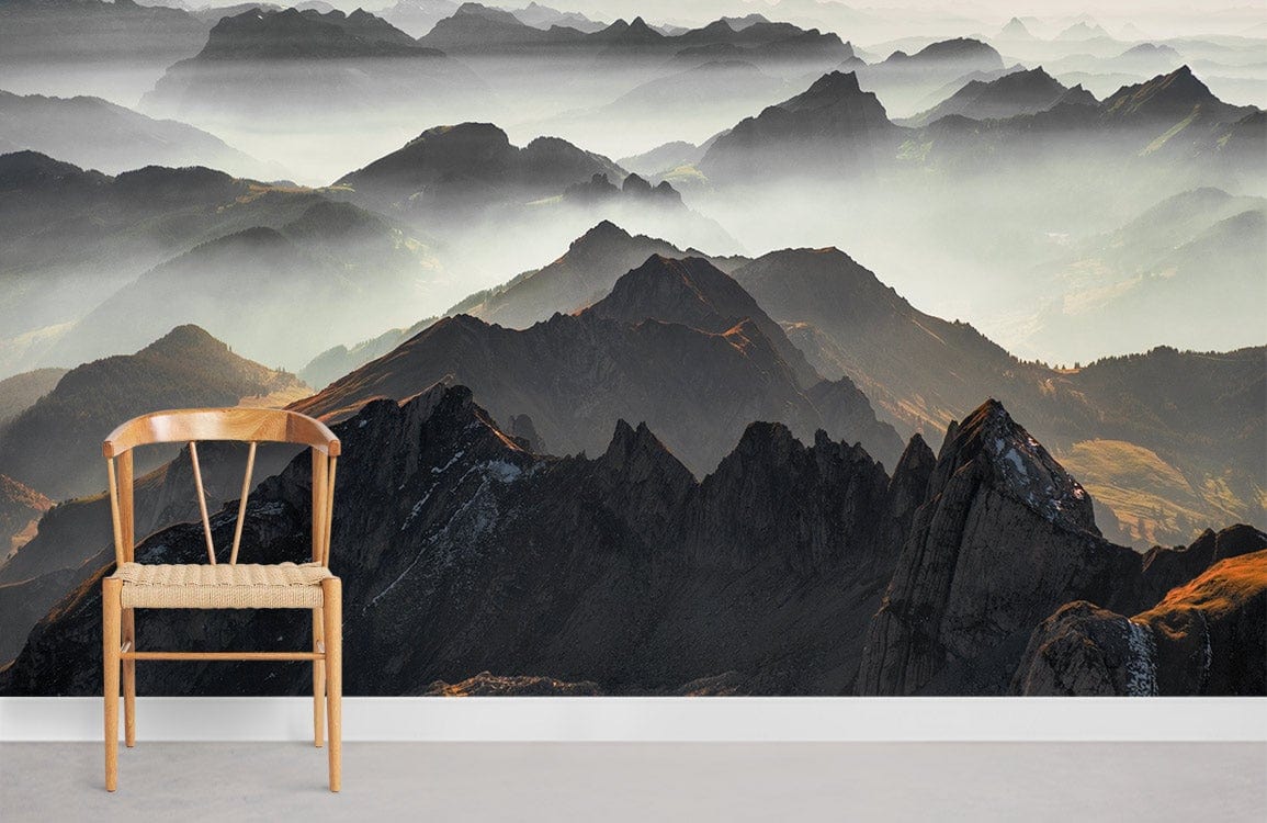 Misty Mountain Range wallpaper mural with wooden chair and grey flooring in living room setting.