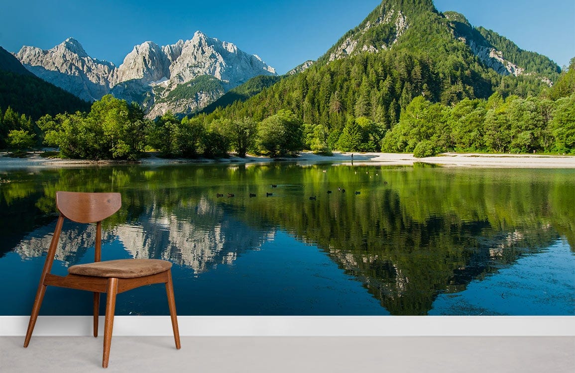 Wooden chair against vibrant Serene Alpine Lake Scenic Landscape mural wallpaper; serene living room decor.