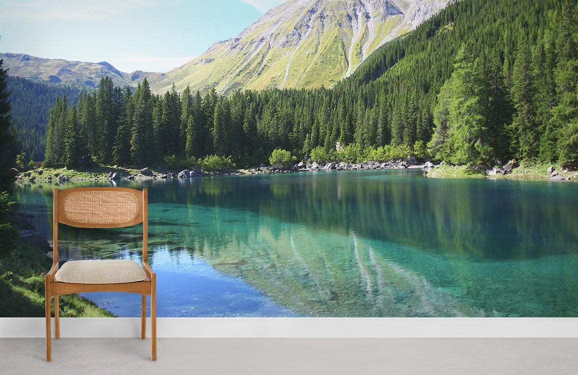 Chair with beige cushion beside serene alpine lake and forest mural wallpaper, vibrant landscape decor.