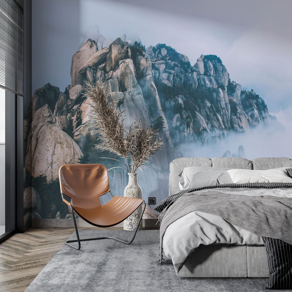Serene Mountain Mist Mural in stylish bedroom, featuring grey bed, modern chair, and wooden flooring.