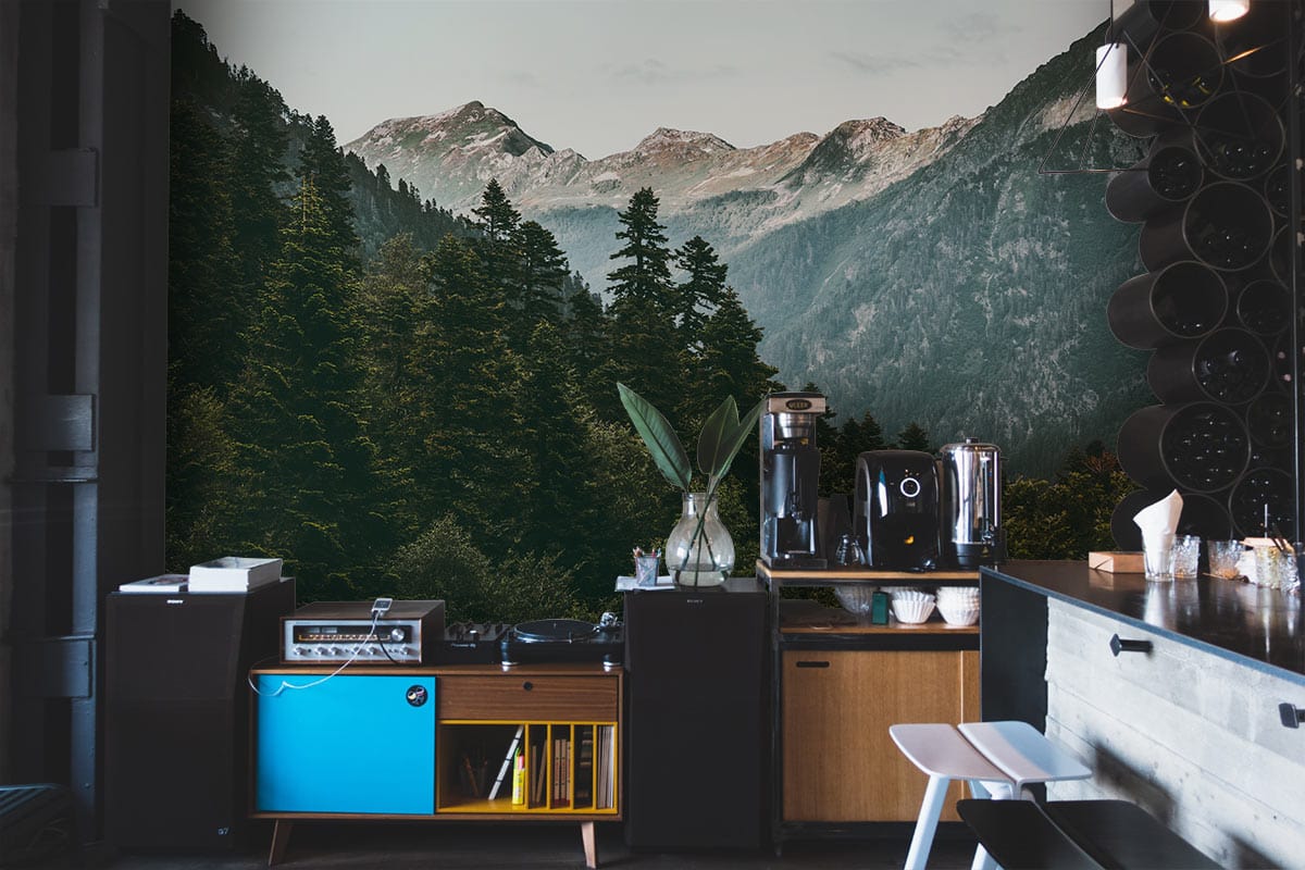 Serene Mountain Forest Mural Wallpaper in kitchen with modern cabinets, bar stools, and scenic forest view.