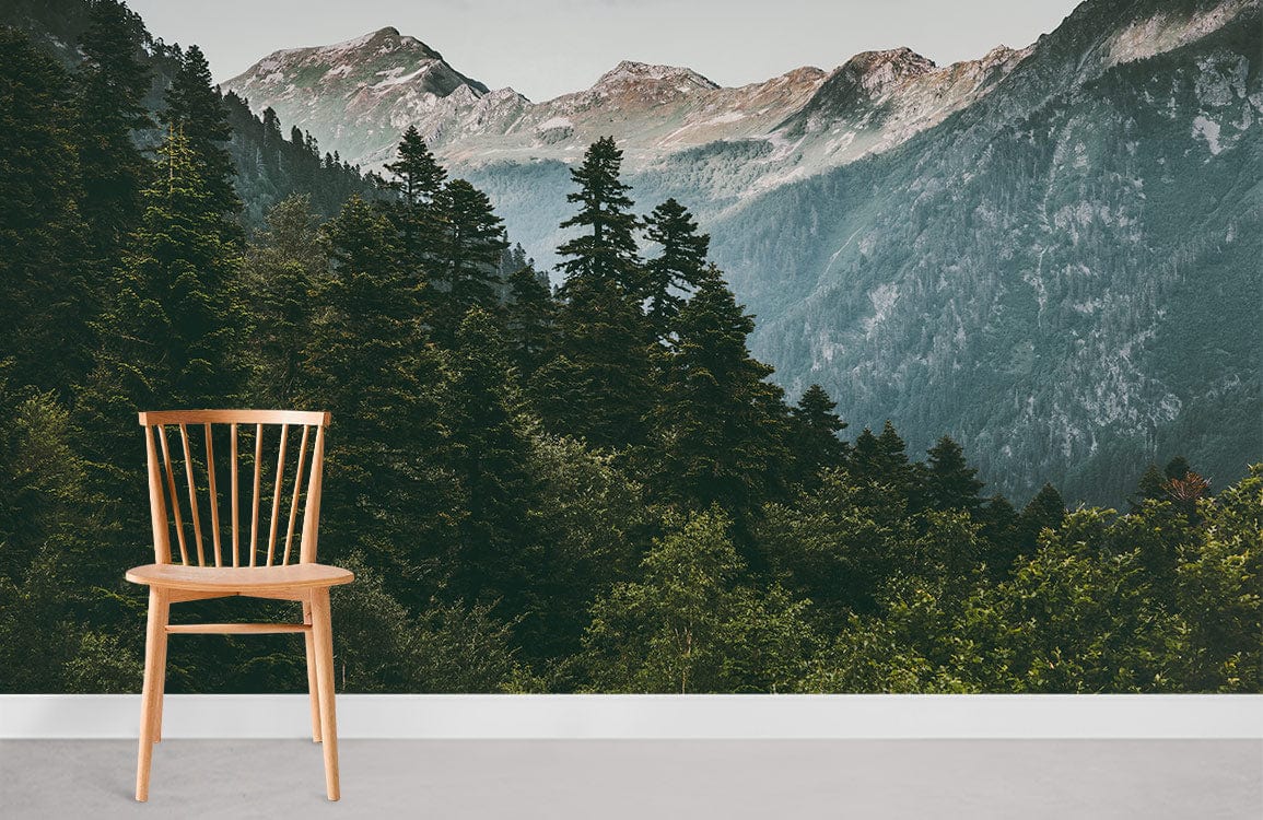 Chair in room with Serene Mountain Forest Mural Wallpaper: lush green landscape; grey flooring.