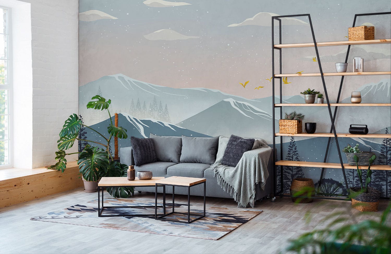 Tranquil Mountain Vista Mural in living room with grey sofa, wooden floor, and black shelving unit.