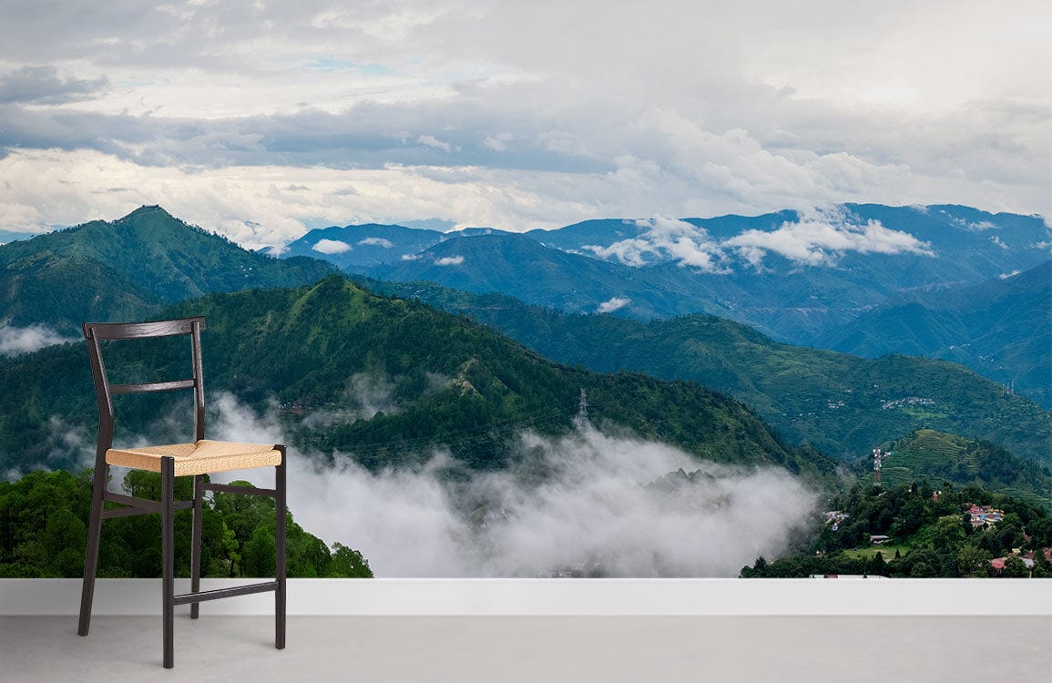Serene Misty Mountain Green Landscape Mural Wallpaper with wooden chair in minimalist white room.
