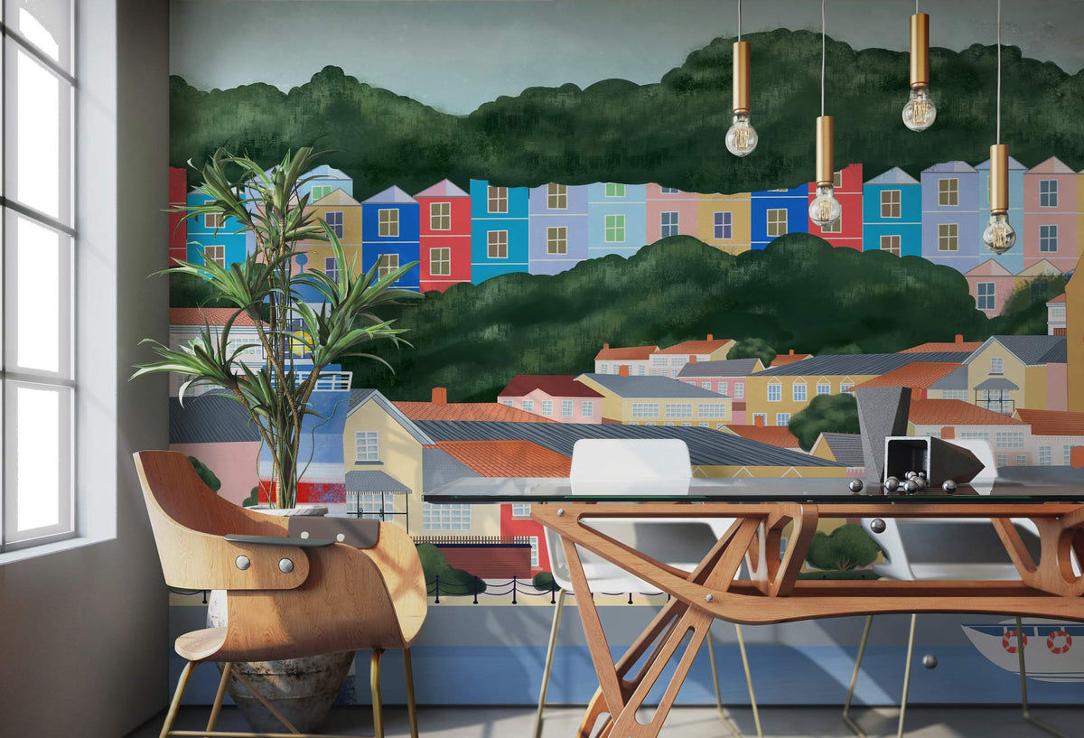 Scenic coastal town mural wallpaper in pastel style, modern chairs, wooden furniture, minimalist office setting.