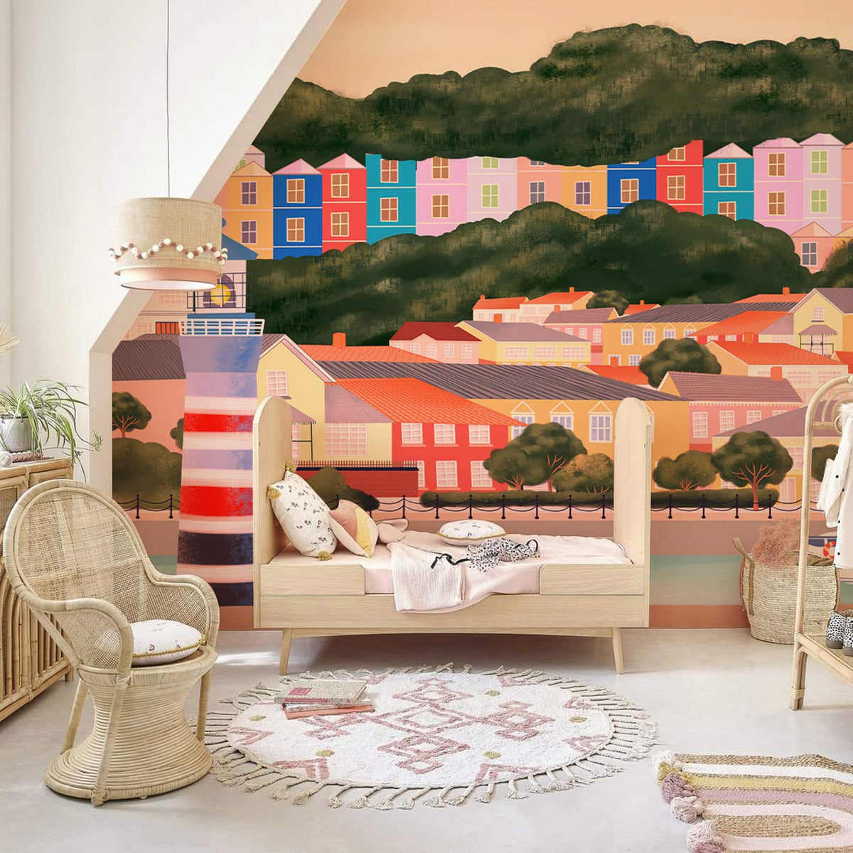 Rattan furniture complements Vibrant Coastal Harbour mural; colourful seaside town illustration decor enhances children's room.