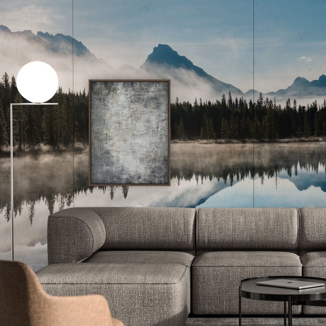 Grey L-shaped sofa, Tranquil Mountain Lake mural, Misty Blue Serenity, contemporary artwork, living room design.