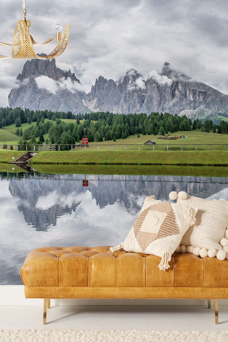 Serene mountain mural wallpaper; leather sofa, wool rug, rustic room; brand unknown, no dimensions visible.