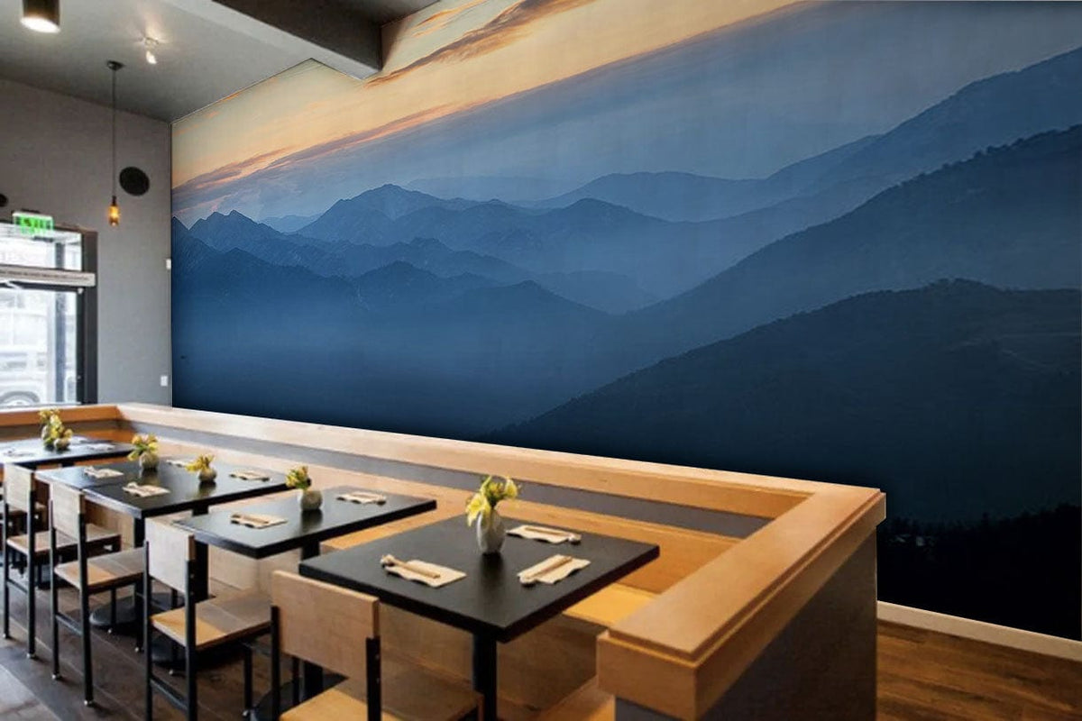 Tranquil Mountain Mist mural in blue gradient decorates café with wooden seating, modern lighting, wood flooring.
