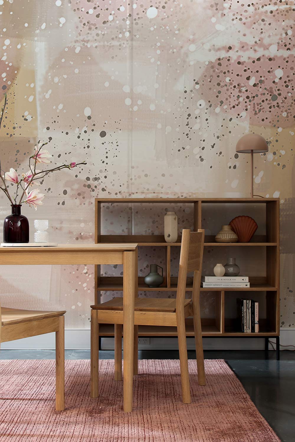 Abstract Blush Beige Paint Mural Wallpaper in dining room with wooden furniture and pink rug flooring.