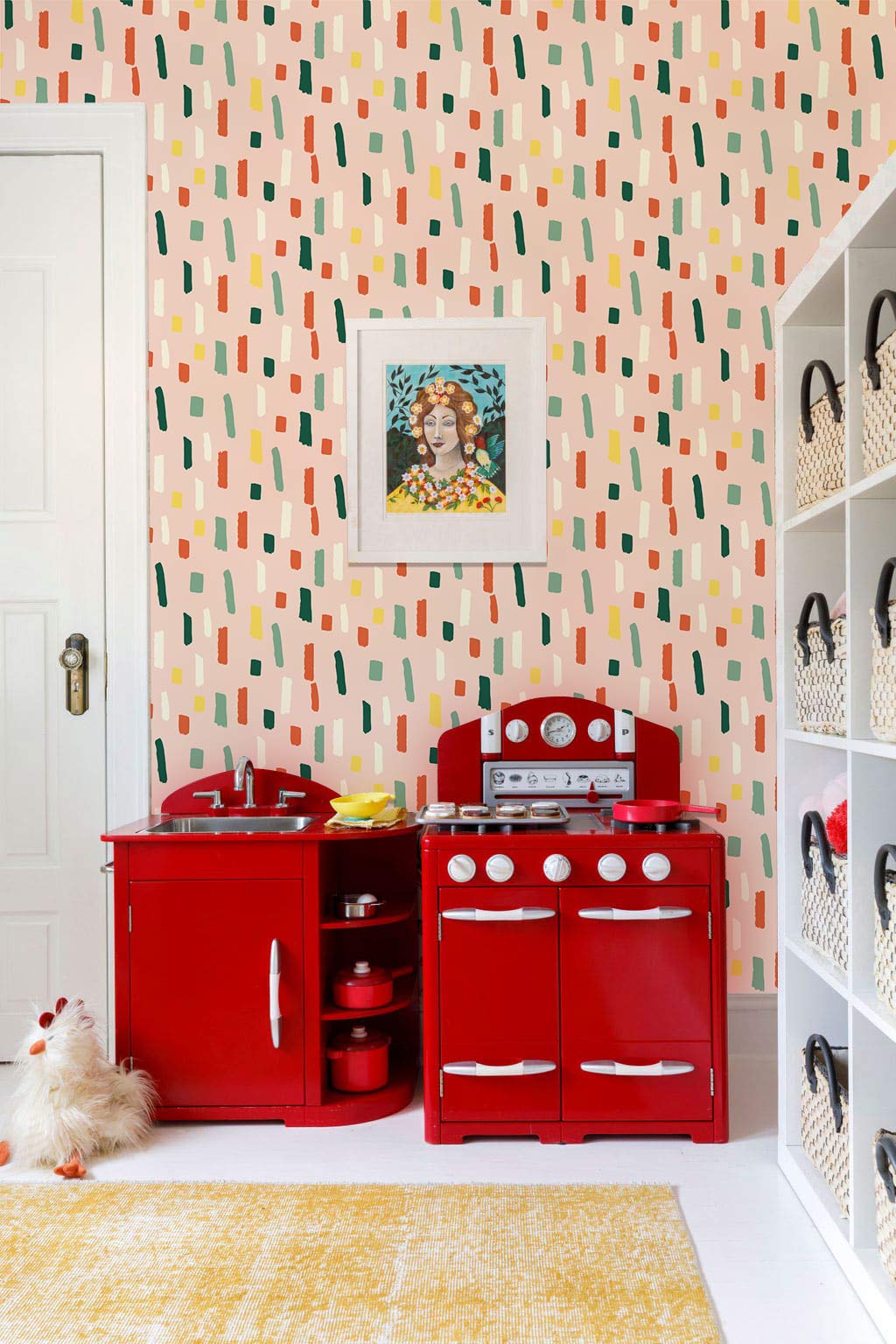 Vintage Pastel Geometric Pattern Wallpaper in playroom with red toy kitchen and white shelving units.