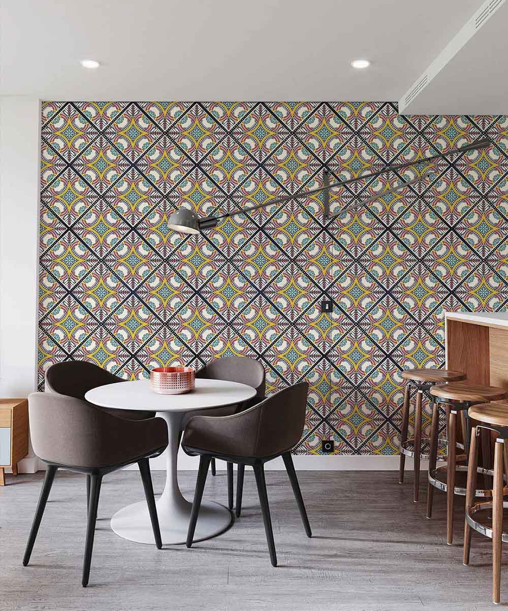 Vibrant retro geometric wallpaper, modern chairs, round white table, wooden bar stools, grey flooring.