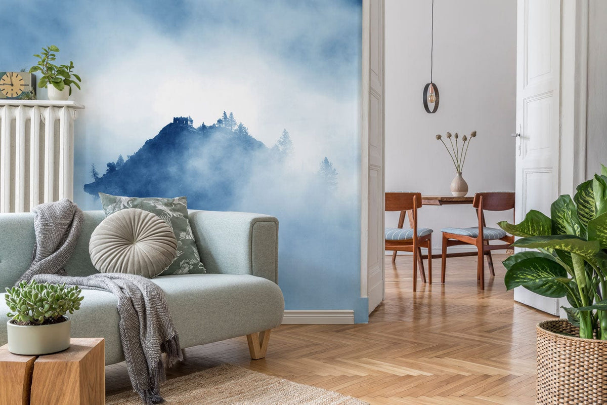 Misty blue mountain mural wallpaper in living room with grey sofa, wood flooring, and serene decor.