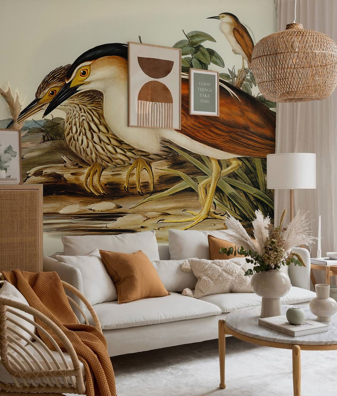 Vintage Bird Illustration Wallpaper in earthy tones; ivory sofa, wicker chair, beige rug, soft lighting.