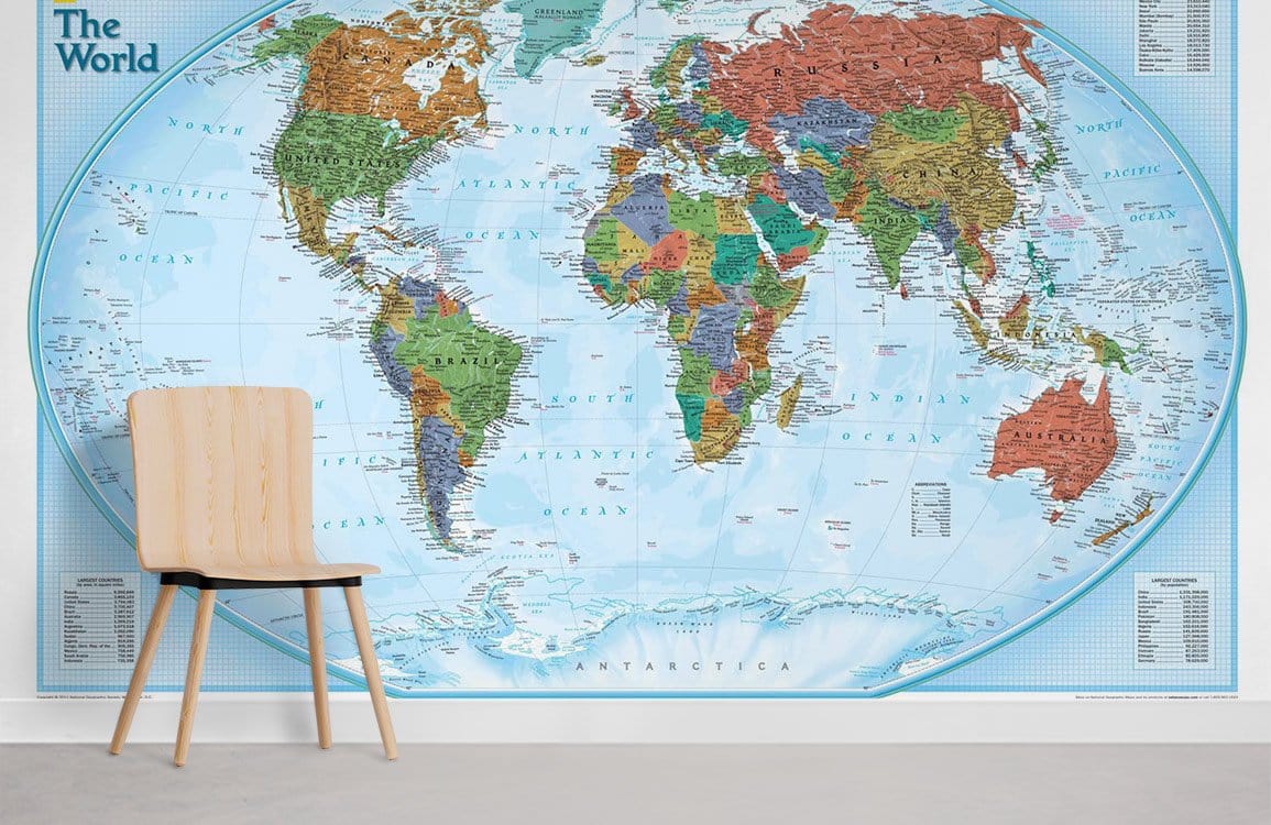 Classic world map mural wallpaper in modern room with wooden chair and light grey flooring.