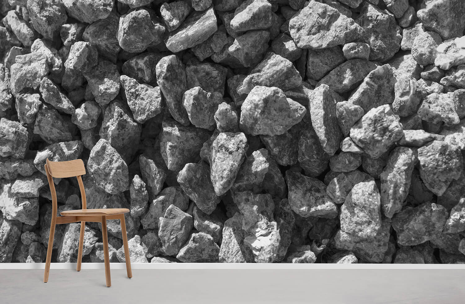 Grey stone wallpaper in rustic pattern, featuring wooden chair on light floor, minimalist decor style.