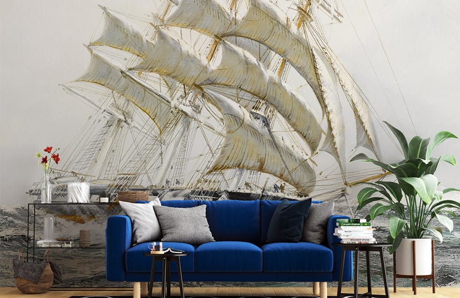 Vintage nautical sailing ship mural wallpaper with blue sofa, subtle sea tones, living room setting.