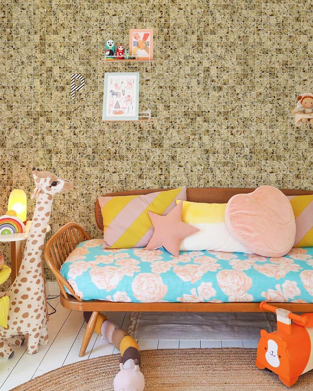 Rustic beige mosaic wallpaper in playful kids' room with wooden sofa, colourful cushions, giraffe lamp.