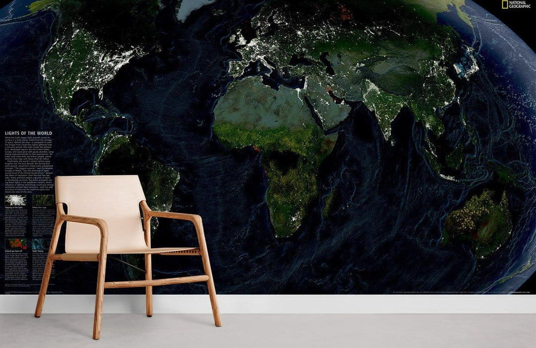 Illuminated Earth wallpaper mural with modern wooden chair, grey flooring, and vibrant night world map.