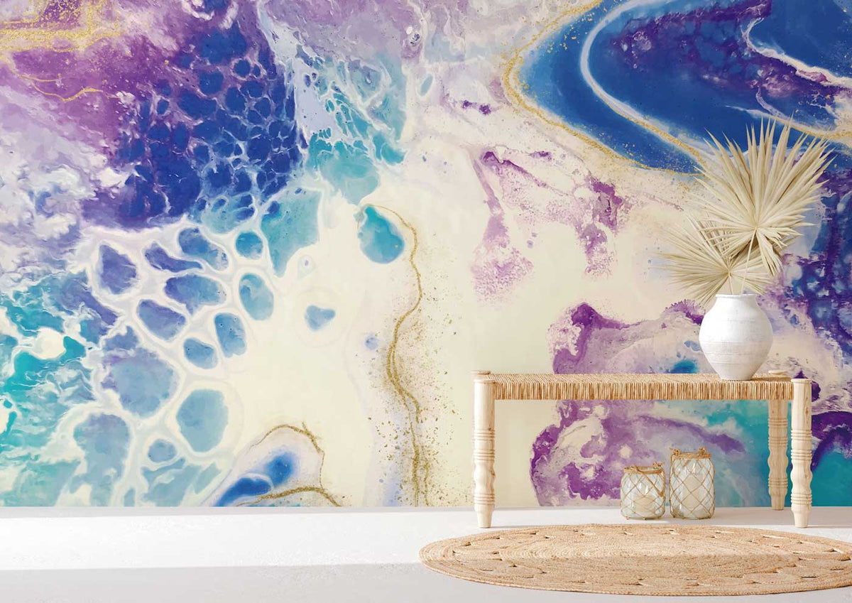 Vibrant oceanic swirl mural wallpaper with stylish table, white vase, woven rug, and neutral flooring.