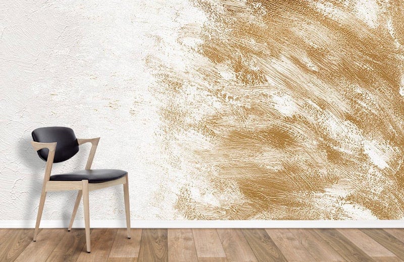 Elegant gold and ivory abstract mural wallpaper with modern chair, wood flooring in contemporary room.