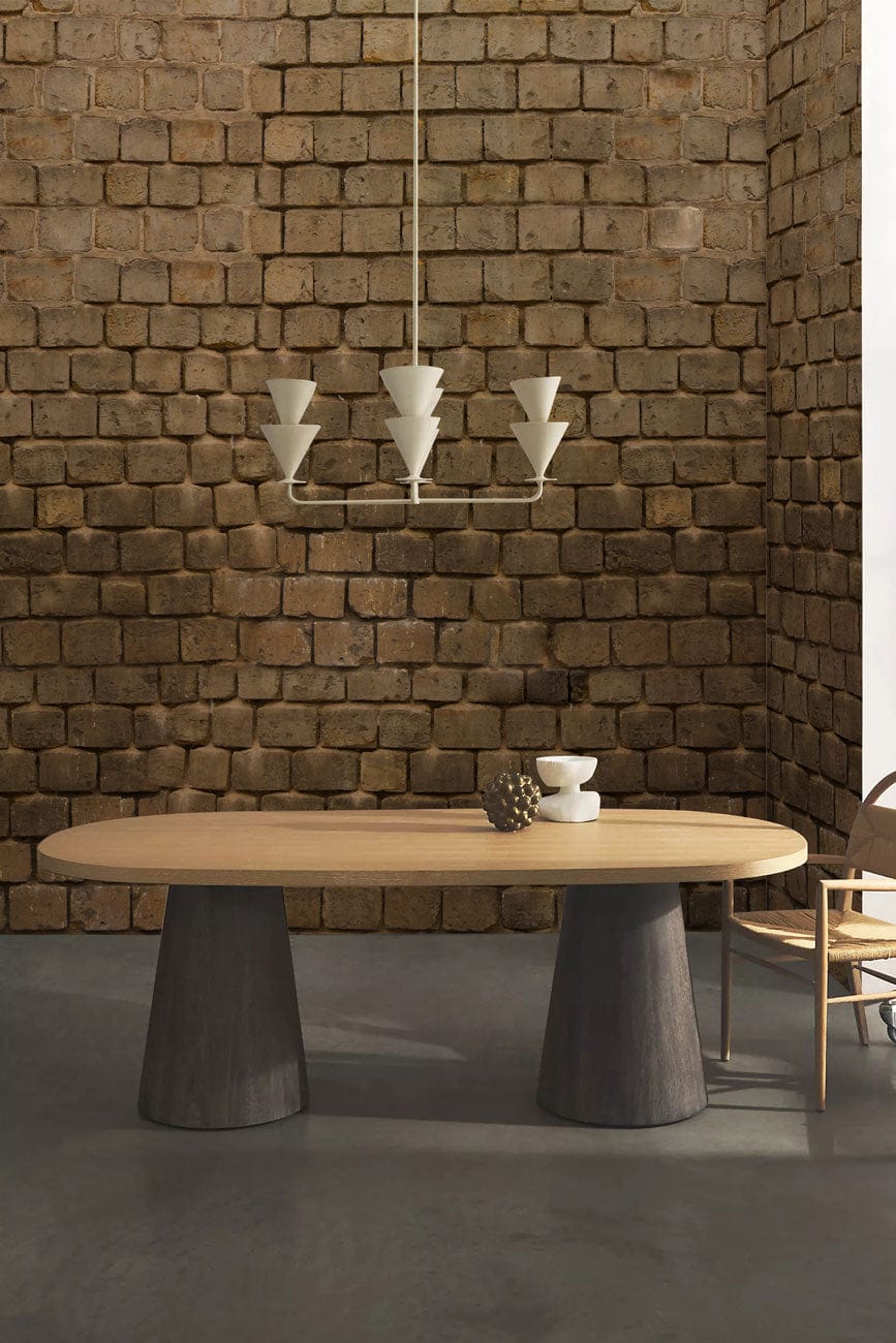 Rustic stone wall wallpaper; earthy tones, dining table, contemporary chairs, pendant lights, concrete floor.