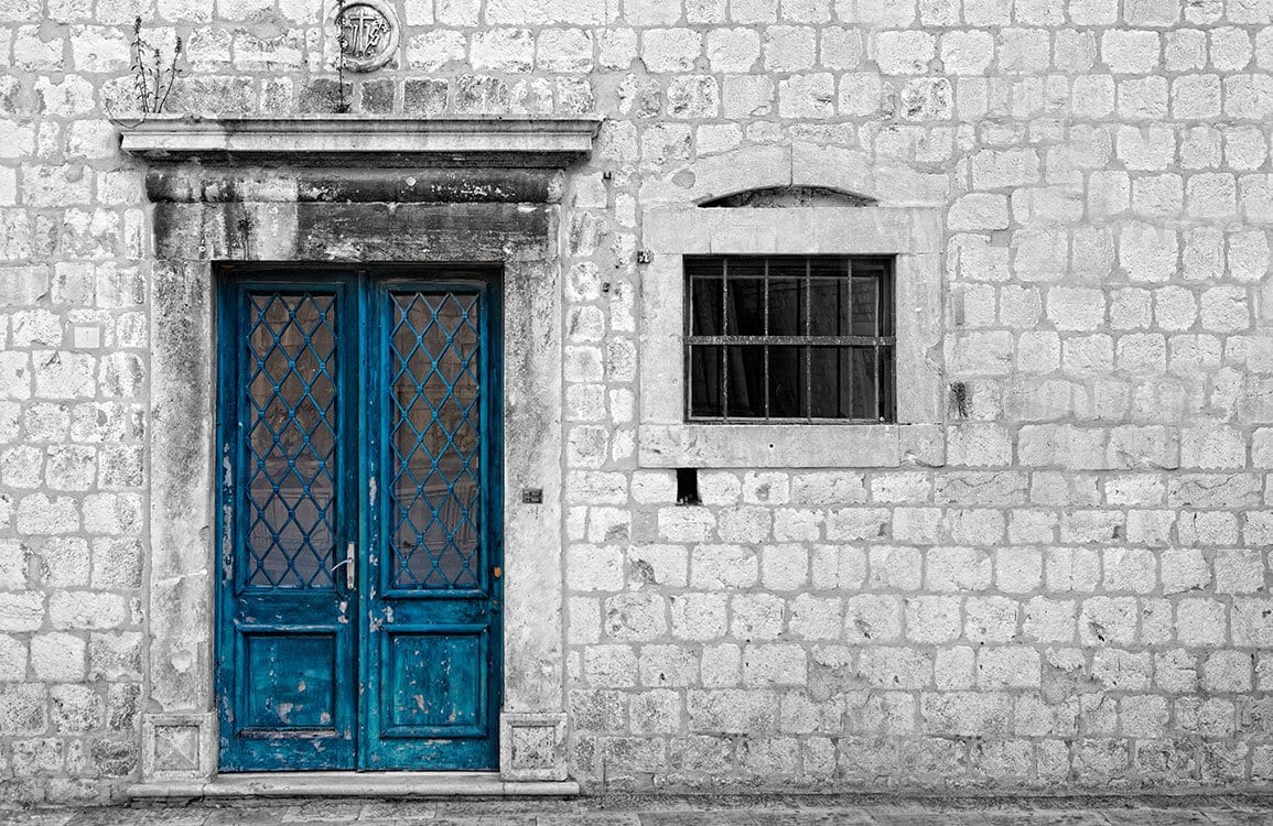 Vintage Stone Wall Mural with Distressed Blue Door Urban Charm
