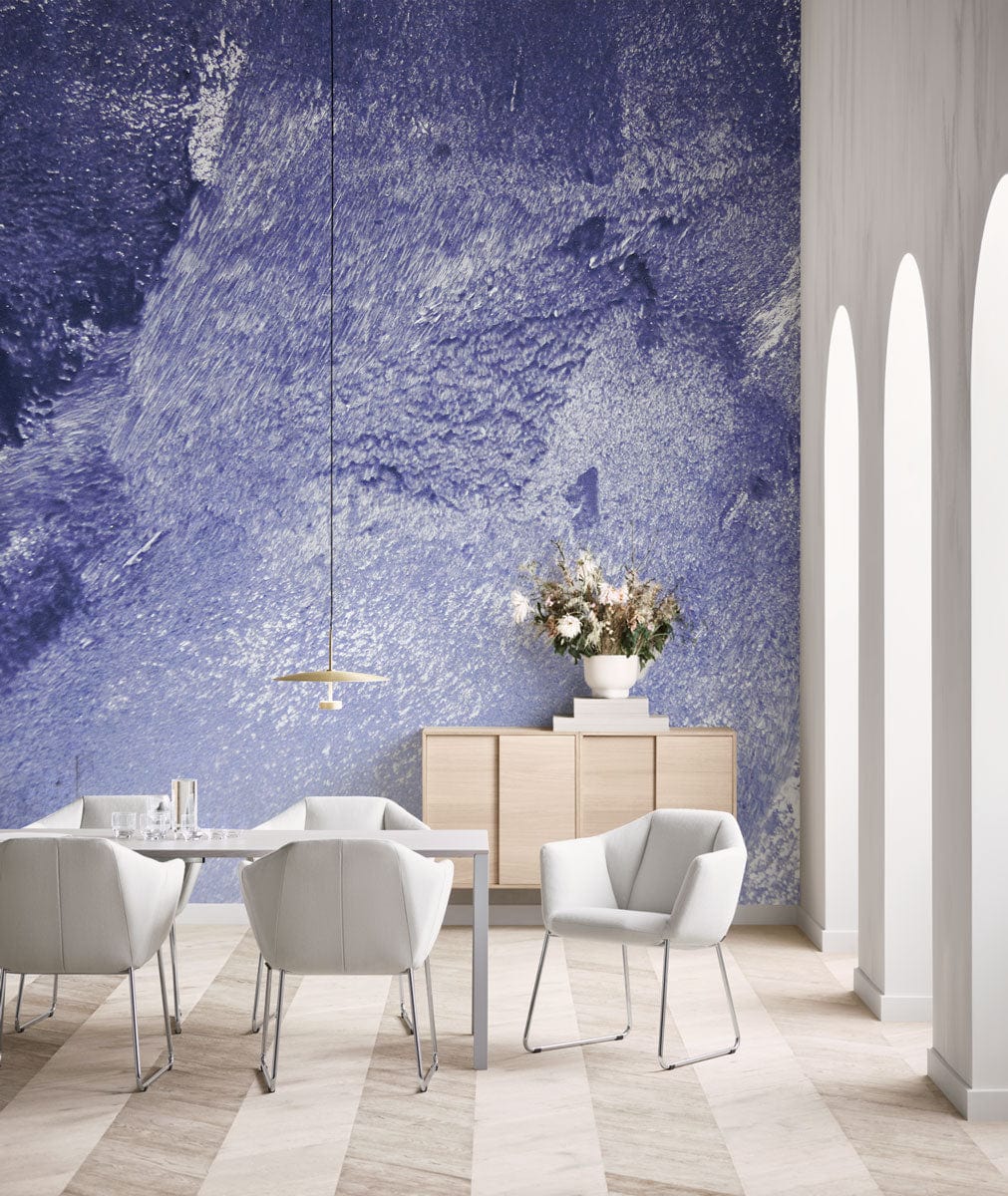 Abstract Textured Blue Mural Wallpaper accents modern dining room with white chairs, wooden floor, archways.