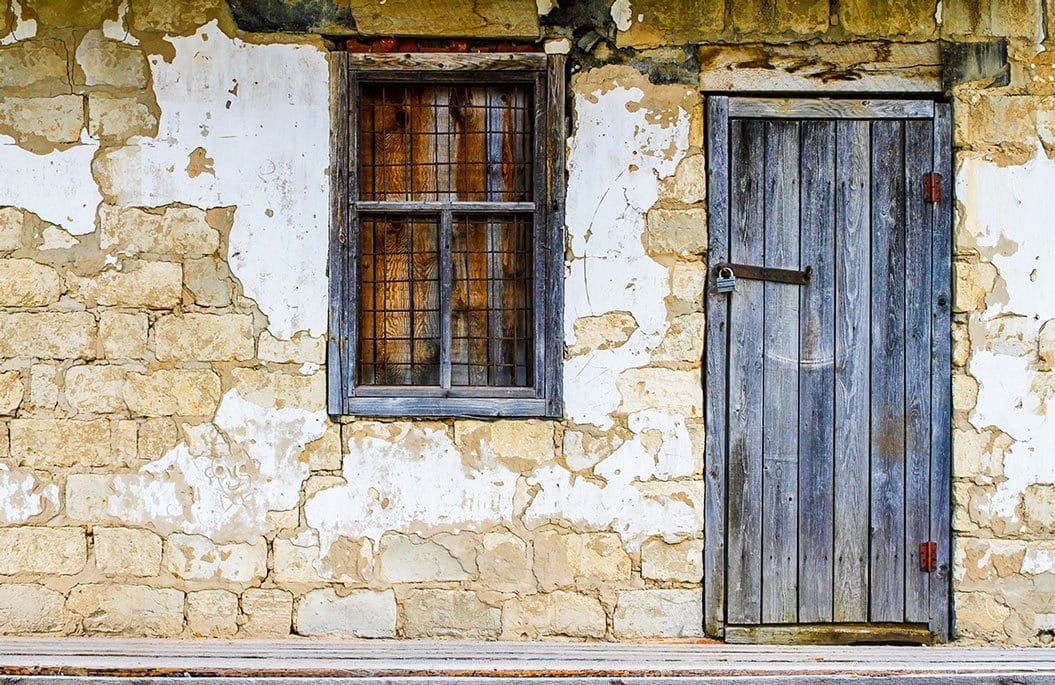Rustic Stone Cottage Wall Mural with Weathered Door and Window