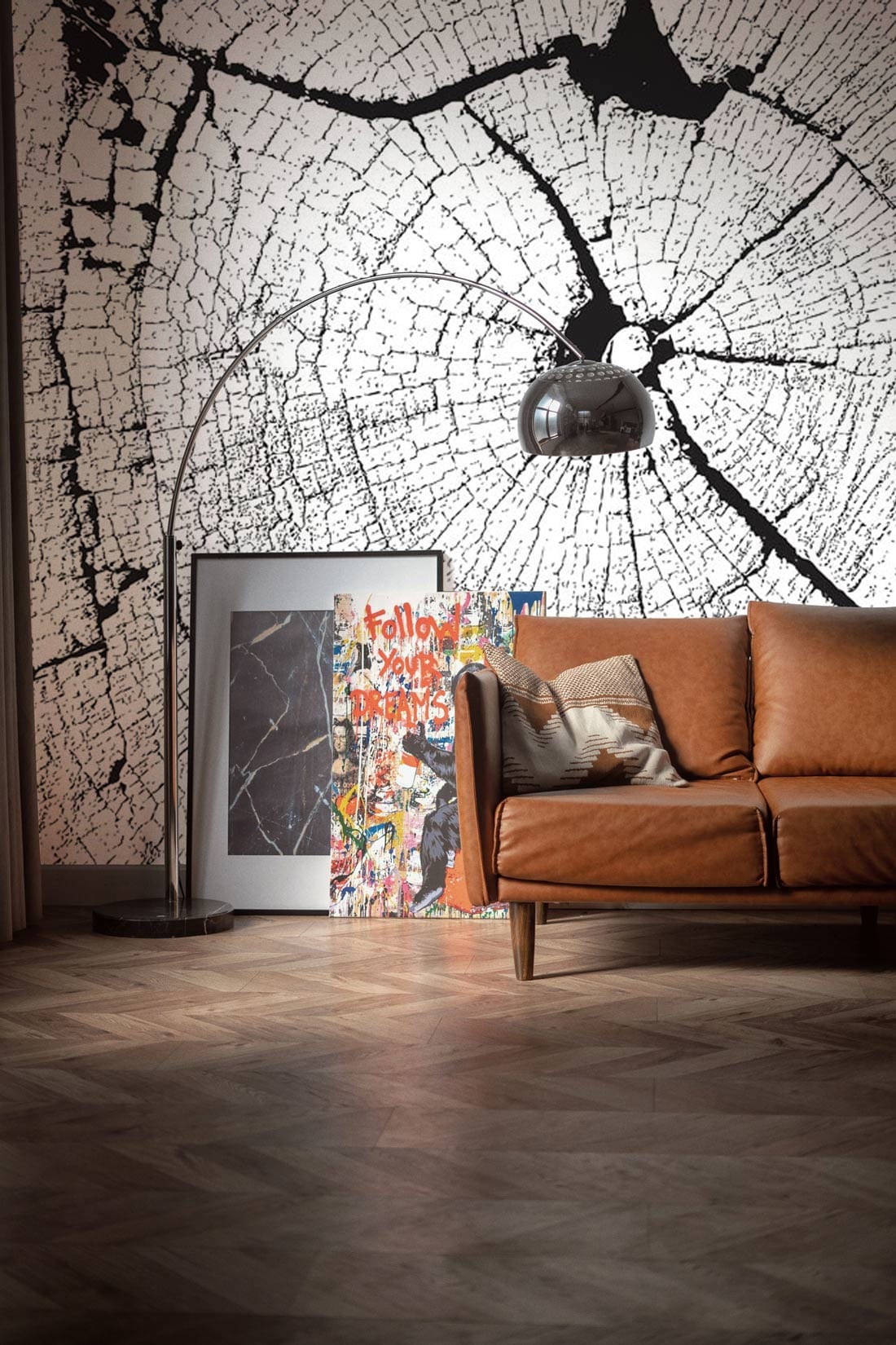 Monochrome rustic wallpaper mural with brown leather sofa, wooden flooring, and modern lamp in living room.