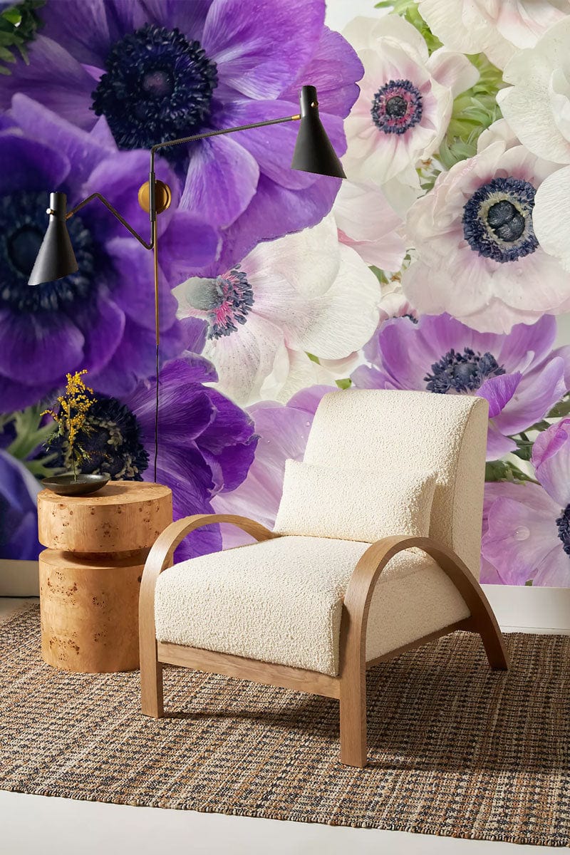 Elegant purple and white anemone floral mural wallpaper, modern armchair, rug, and stylish lighting in room.