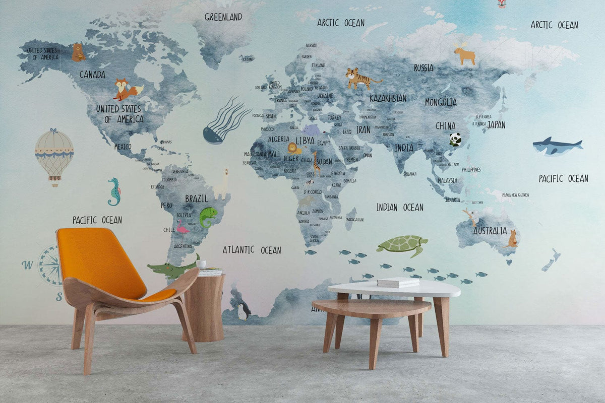 Whimsical World Map mural wallpaper in blue, featuring armchair, tables, concrete floor in living room.