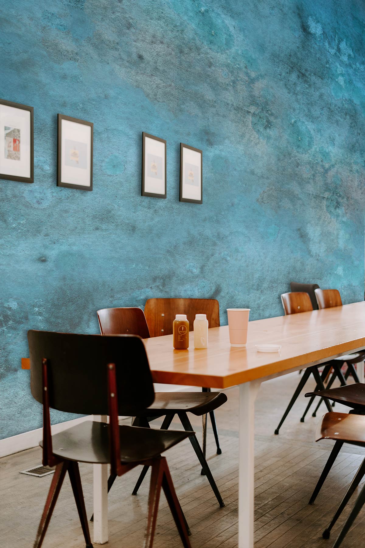 Tranquil Blue Watercolour Mural Wallpaper in dining room with brown chairs, wooden table, and framed art.