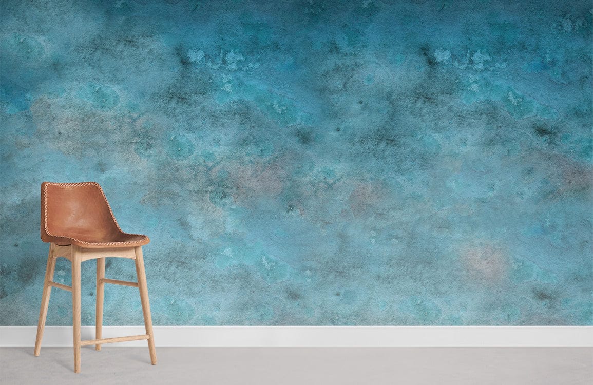Tranquil blue watercolour mural wallpaper in living room with tan chair and grey flooring.