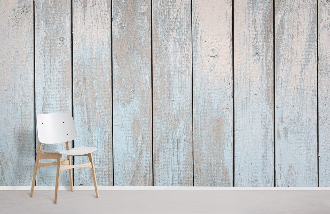 Rustic light blue wooden plank effect wallpaper with vintage decor, featuring minimalist white chair.