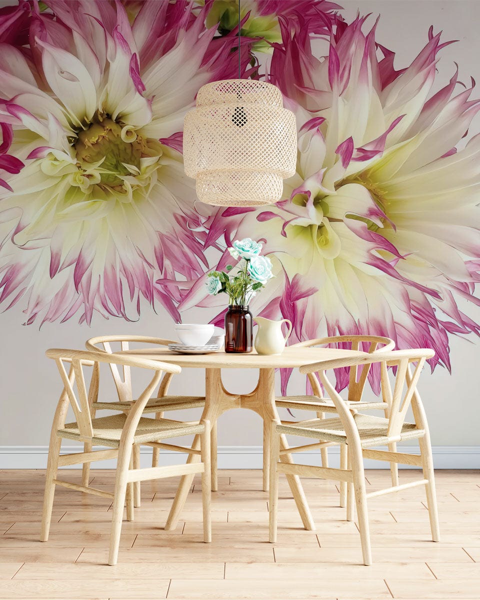 Vibrant pink and white dahlia wallpaper with light wood dining table, chairs, and wicker lampshade.