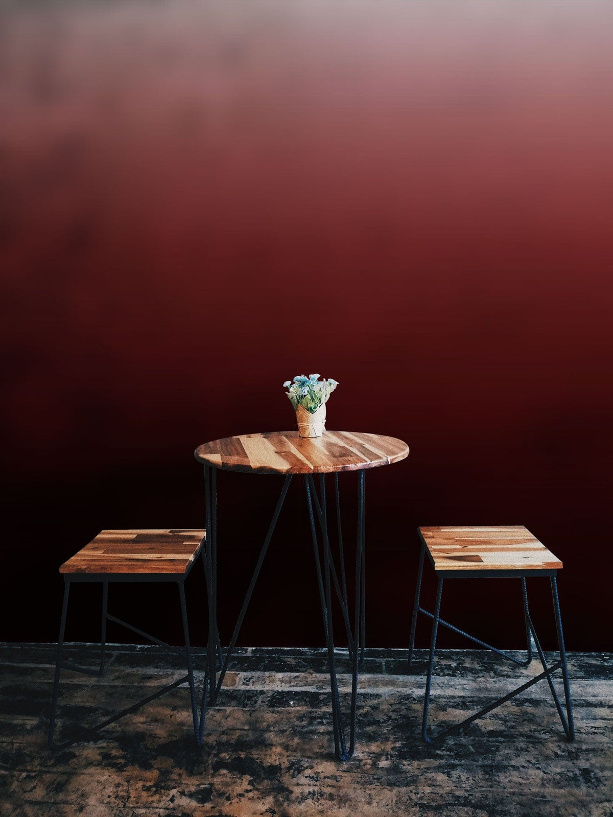 Elegant red gradient ombre wallpaper, wooden table and stools, dark rustic flooring, modern decor.