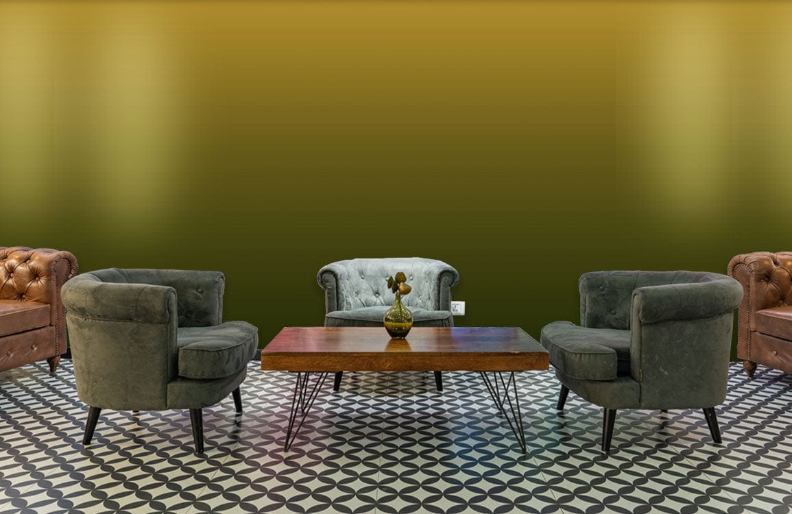 Golden Olive Ombre Wallpaper in modern living room with grey sofas and geometric patterned flooring.