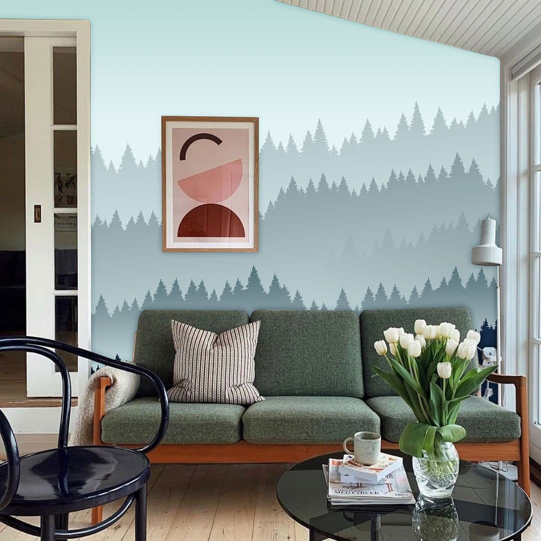 Misty Blue Forest Landscape Mural in living room with green sofa, wood flooring, and modern decor.