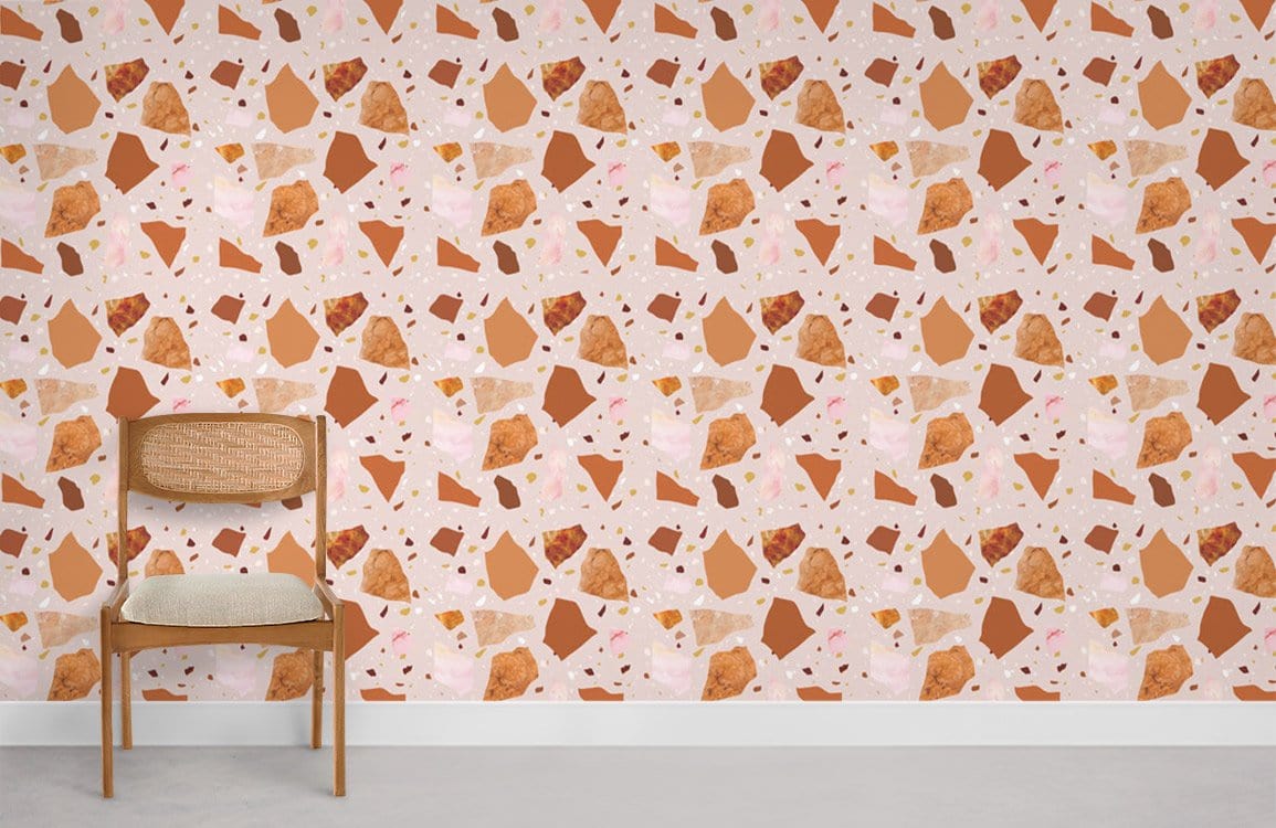 Terracotta and blush terrazzo wallpaper in modern room with wooden chair, white skirting, concrete flooring.