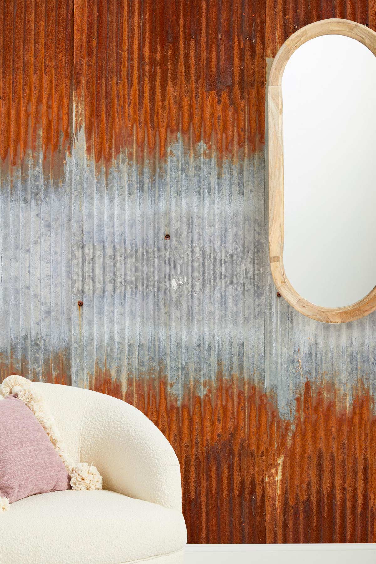 Rustic wallpaper with corrugated metal pattern, orange-grey hues; beige textured chair, oval wooden mirror.
