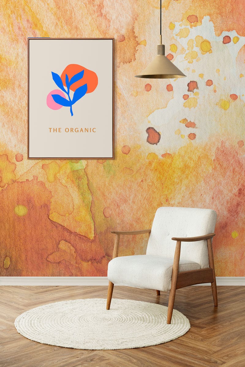 Warm Watercolour Abstract Wallpaper with white armchair, wooden flooring, and hanging light in modern room.