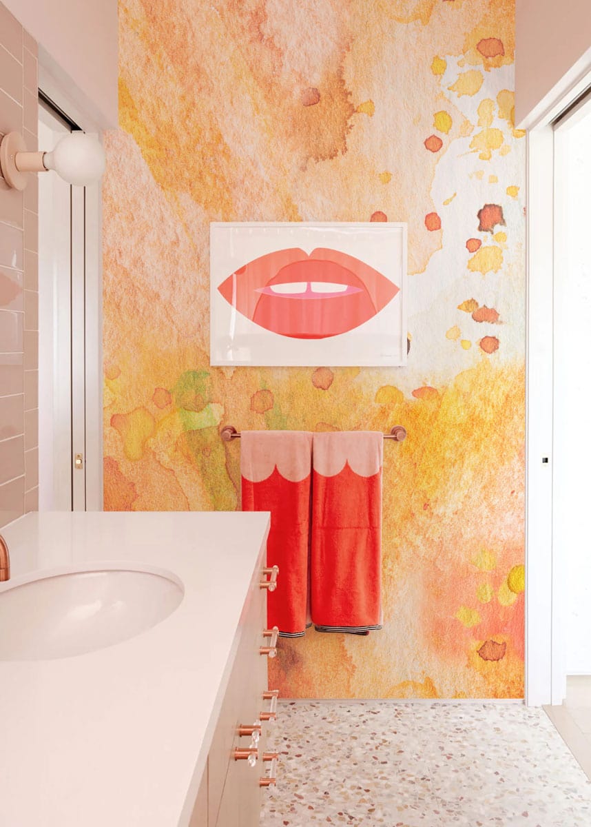 Warm Watercolour Abstract Wallpaper in bathroom with terrazzo floor and modern vanity, featuring bold artwork.